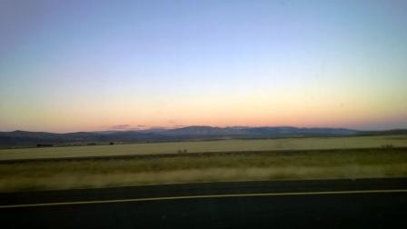 Pink sky behind blue hills